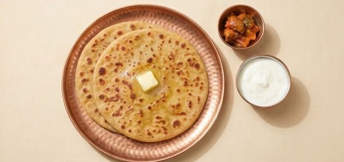 Aloo paratha with butter, pickle and curd
